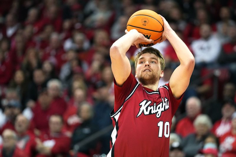 Feb 18, 2023; Madison, Wisconsin, USA;  Rutgers Scarlet Knights guard Cam Spencer (10) shoots a three-pointer against the Wisconsin Badgers during the first half at the Kohl Center. Mandatory Credit: Kayla Wolf-USA TODAY Sports