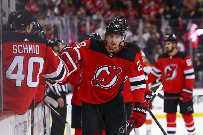 Dec 19, 2023; Newark, New Jersey, USA; New Jersey Devils center Michael McLeod (20) celebrates his goal against the Philadelphia Flyers during the first period at Prudential Center. Mandatory Credit: Ed Mulholland-USA TODAY Sports