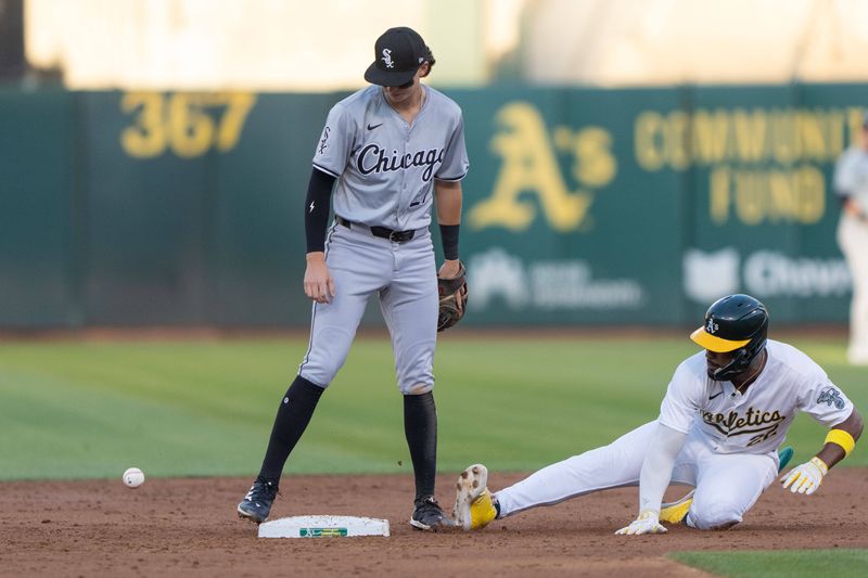 Aug 6, 2024; Oakland, California, USA;  Chicago White Sox shortstop Brooks Baldwin (27) watches the ball during the third inning as Oakland Athletics outfielder Miguel Andujar (22) slides at Oakland-Alameda County Coliseum. Mandatory Credit: Stan Szeto-USA TODAY Sports