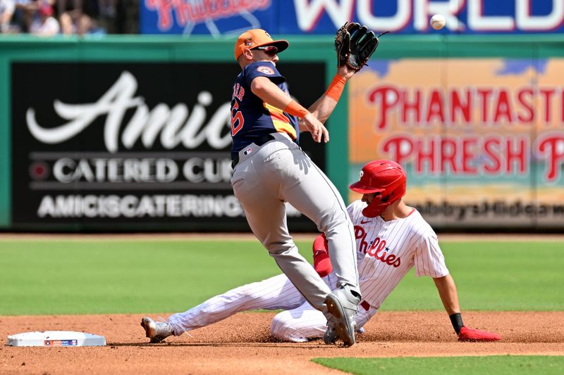 Mar 8, 2024; Clearwater, Florida, USA; Philadelphia Phillies shortstop Trea Turner (7) slides into second base as Houston Astros shortstop Grae Kessinger (16) waits for the ball in the first inning of the spring training game at BayCare Ballpark. Mandatory Credit: Jonathan Dyer-USA TODAY Sports