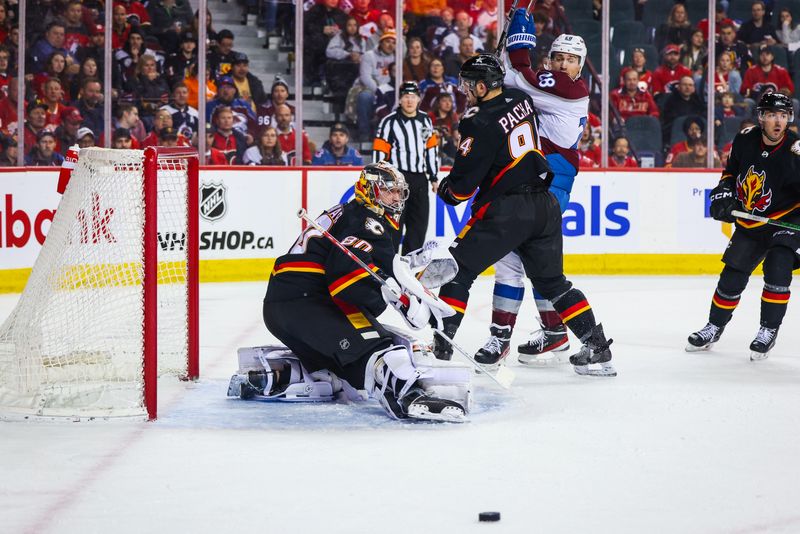 Mar 12, 2024; Calgary, Alberta, CAN; Calgary Flames goaltender Dan Vladar (80) makes a save against the Colorado Avalanche during the first period at Scotiabank Saddledome. Mandatory Credit: Sergei Belski-USA TODAY Sports