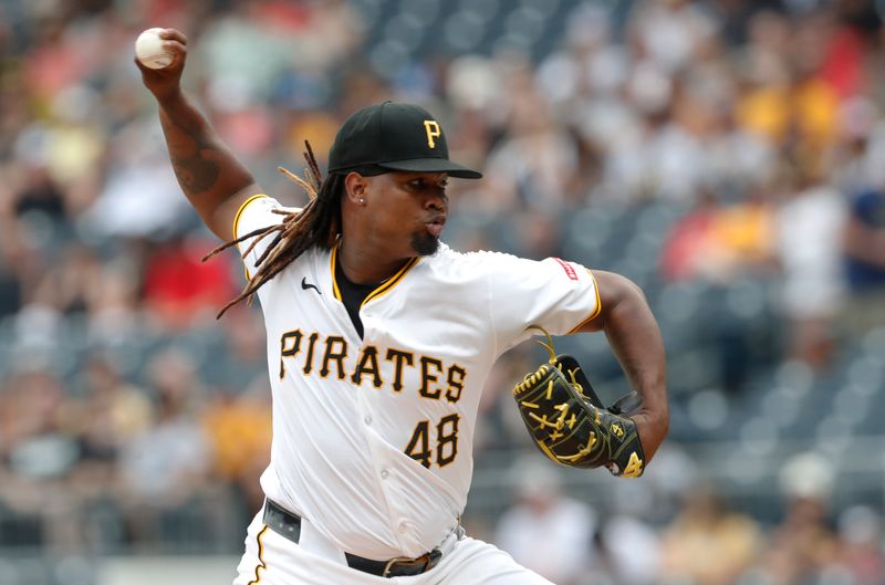 Aug 25, 2024; Pittsburgh, Pennsylvania, USA;  Pittsburgh Pirates starting pitcher Luis L. Ortiz (48) delivers a pitch against the Cincinnati Reds during the first inning at PNC Park. Mandatory Credit: Charles LeClaire-USA TODAY Sports