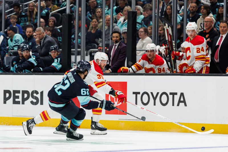 Oct 19, 2024; Seattle, Washington, USA; Calgary Flames right wing Anthony Mantha (39) skates as Seattle Kraken defenseman Brandon Montour (62) defends during the second period at Climate Pledge Arena. Mandatory Credit: Caean Couto-Imagn Images