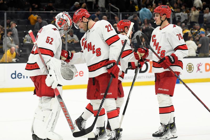 Apr 9, 2024; Boston, Massachusetts, USA; Carolina Hurricanes goaltender Pyotr Kochetkov (52) is congratulated by defenseman Brett Pesce (22) after defeating the Boston Bruins at TD Garden. Mandatory Credit: Bob DeChiara-USA TODAY Sports