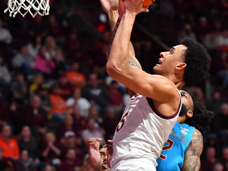 Feb 13, 2024; Blacksburg, Virginia, USA; Virginia Tech Hokies center Lynn Kidd (15) goes up for a shot while being defended by Florida State Seminoles forward Jamir Watkins (2) during the second half at Cassell Coliseum. Mandatory Credit: Brian Bishop-USA TODAY Sports