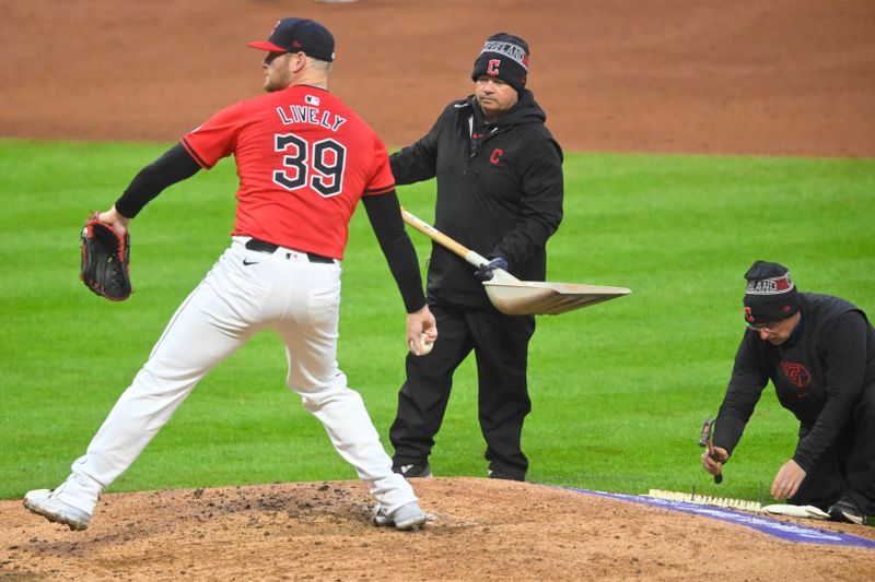 Apr 23, 2024; Cleveland, Ohio, USA; Cleveland Guardians starting pitcher Ben Lively (39) warms up as members of the grounds crew work on the mound in the third inning against the Boston Red Sox at Progressive Field. Mandatory Credit: David Richard-USA TODAY Sports