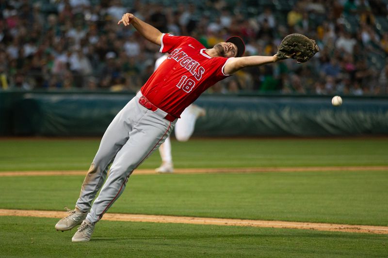 Jul 3, 2024; Oakland, California, USA; Los Angeles Angels first baseman Nolan Schanuel (18) cannot make the catch of a foul popup off the bat of Oakland Athletics second baseman Zack Gelof during the seventh inning at Oakland-Alameda County Coliseum. Mandatory Credit: D. Ross Cameron-USA TODAY Sports