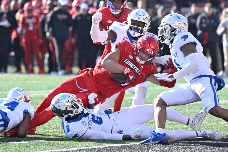 Nov 25, 2023; Louisville, Kentucky, USA; Louisville Cardinals tight end Joey Gatewood (84) lunges over Kentucky Wildcats defensive back Jonquis Hardaway (6) to score a touchdown during the second half at L&N Federal Credit Union Stadium. Kentucky defeated Louisville 38-31. Mandatory Credit: Jamie Rhodes-USA TODAY Sports