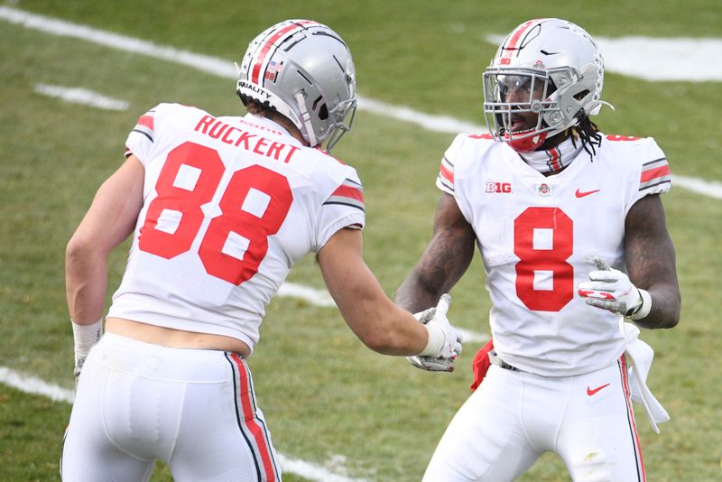 Dec 5, 2020; East Lansing, Michigan, USA; Ohio State Buckeyes running back Trey Sermon (8) high fives tight end Jeremy Ruckert (88) after scoring a touchdown during the third quarter against the Michigan State Spartans at Spartan Stadium. Mandatory Credit: Tim Fuller-USA TODAY Sports