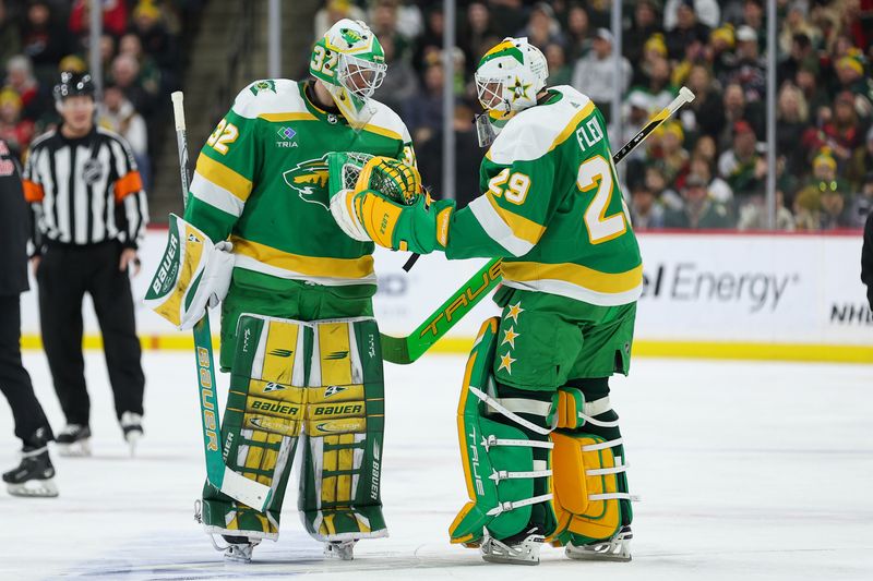 Jan 13, 2024; Saint Paul, Minnesota, USA; Minnesota Wild goaltender Marc-Andre Fleury (29) and Minnesota Wild goaltender Filip Gustavsson (32) exchange words during the second period at Xcel Energy Center. Mandatory Credit: Matt Krohn-USA TODAY Sports