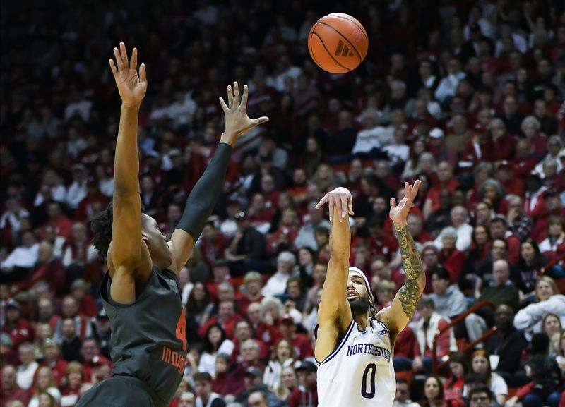 Feb 18, 2024; Bloomington, Indiana, USA;  Northwestern Wildcats guard Boo Buie (0) attempts a shot over Indiana Hoosiers forward Anthony Walker (4) during the second half at Simon Skjodt Assembly Hall. Mandatory Credit: Robert Goddin-USA TODAY Sports