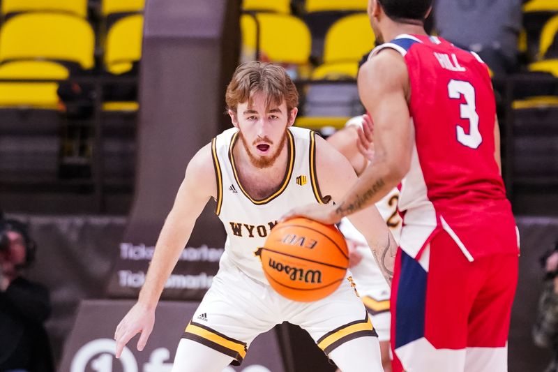 Jan 31, 2023; Laramie, Wyoming, USA; Wyoming Cowboys forward Jake Kyman (13) defends against Fresno State Bulldogs guard Isaiah Hill (3) during the first half at Arena-Auditorium. Mandatory Credit: Troy Babbitt-USA TODAY Sports