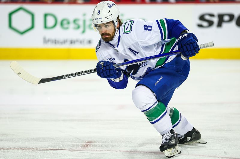 Dec 31, 2024; Calgary, Alberta, CAN; Vancouver Canucks right wing Conor Garland (8) skates against the Calgary Flames during the third period at Scotiabank Saddledome. Mandatory Credit: Sergei Belski-Imagn Images