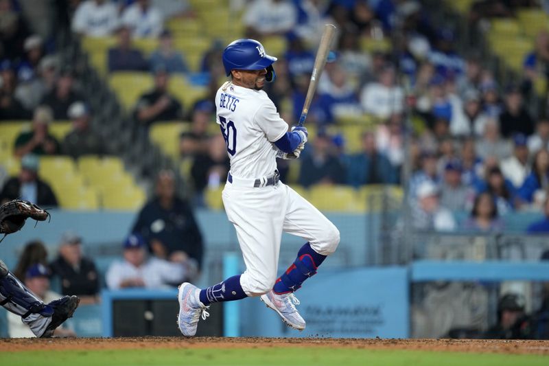 Sep 20, 2023; Los Angeles, California, USA; Los Angeles Dodgers second baseman Mookie Betts (50) hits a double in the eighth inning against the Detroit Tigers at Dodger Stadium. Mandatory Credit: Kirby Lee-USA TODAY Sports