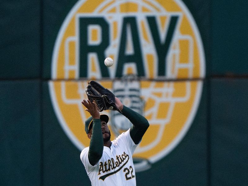 Jun 21, 2024; Oakland, California, USA; Oakland Athletics outfielder Miguel Andujar (22) catches the ball against the Minnesota Twins during the sixth inning at Oakland-Alameda County Coliseum. Mandatory Credit: Stan Szeto-USA TODAY Sports