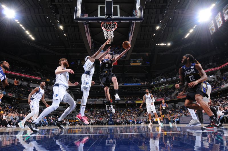 INDIANAPOLIS, IN - MARCH 27: T.J. McConnell #9 of the Indiana Pacers drives to the basket during the game against the Dallas Mavericks on March 27, 2023 at Gainbridge Fieldhouse in Indianapolis, Indiana. NOTE TO USER: User expressly acknowledges and agrees that, by downloading and or using this Photograph, user is consenting to the terms and conditions of the Getty Images License Agreement. Mandatory Copyright Notice: Copyright 2023 NBAE (Photo by Ron Hoskins/NBAE via Getty Images)