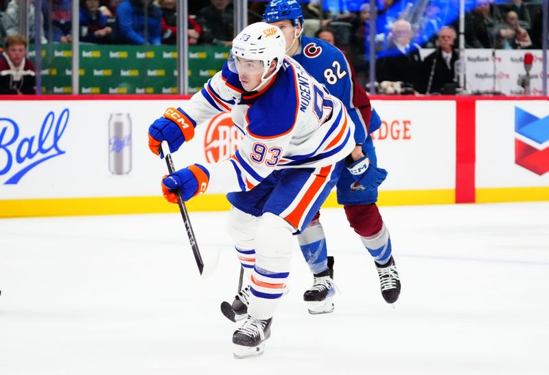 Nov 30, 2024; Denver, Colorado, USA; Edmonton Oilers center Ryan Nugent-Hopkins (93) shoots and scores an empty net goal in the third period against the Colorado Avalanche at Ball Arena. Mandatory Credit: Ron Chenoy-Imagn Images