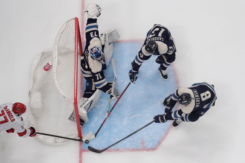 Apr 16, 2024; Columbus, Ohio, USA; Columbus Blue Jackets left wing Johnny Gaudreau (13) stops a wraparound shot of Carolina Hurricanes defenseman Tony DeAngelo (77) during the first period at Nationwide Arena. Mandatory Credit: Russell LaBounty-USA TODAY Sports