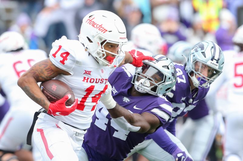 Oct 28, 2023; Manhattan, Kansas, USA; Houston Cougars wide receiver Jonah Wilson (14) stiff arms Kansas State Wildcats linebacker Tobi Osunsanmi (44) during the third quarter at Bill Snyder Family Football Stadium. Mandatory Credit: Scott Sewell-USA TODAY Sports