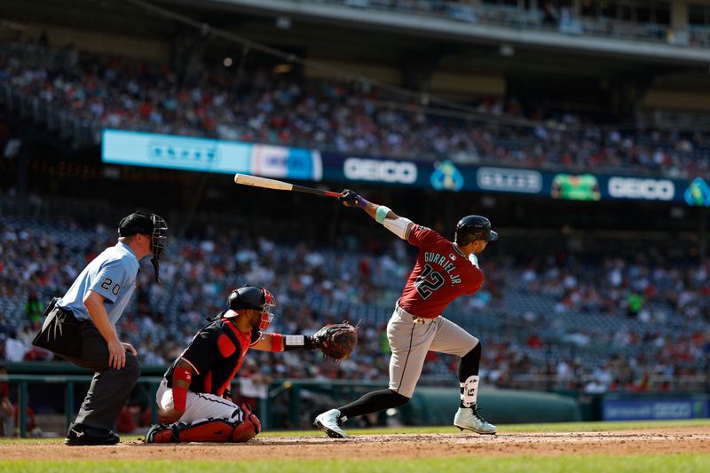 Jun 19, 2024; Washington, District of Columbia, USA; Arizona Diamondbacks outfielder Lourdes Gurriel Jr. (12) singles against the Washington Nationals during the fourth inning at Nationals Park. Mandatory Credit: Geoff Burke-USA TODAY Sports