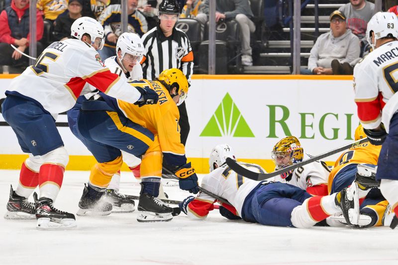 Nov 24, 2025; Nashville, Tennessee, USA;  Florida Panthers goaltender Daniil Tarasov (40) and defenseman Niko Mikkola (77) blocks the shot of Nashville Predators right wing Luke Evangelista (77) during the first period at Bridgestone Arena. Mandatory Credit: Steve Roberts-Imagn Images
