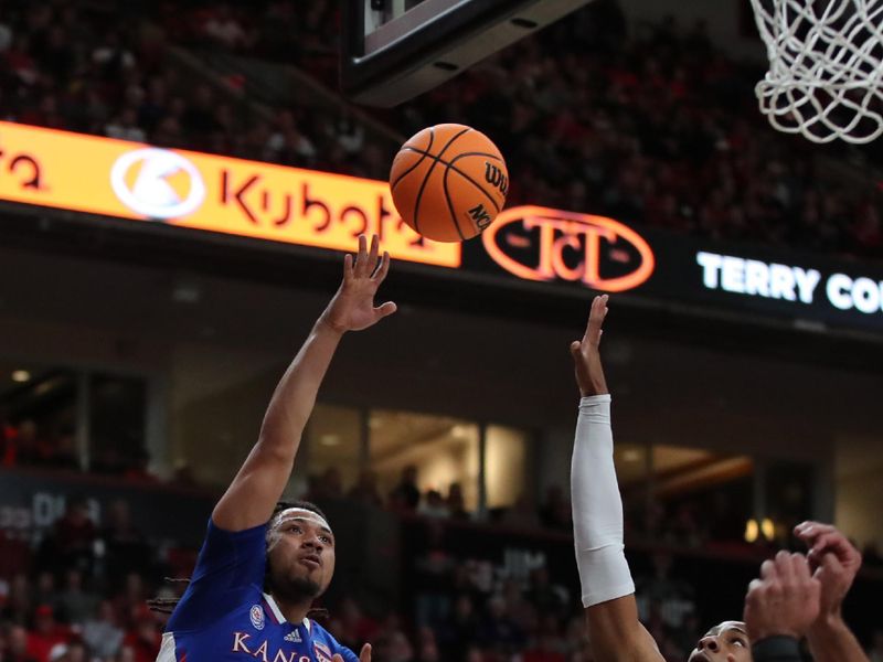 Jan 3, 2023; Lubbock, Texas, USA;  Kansas Jayhawks guard Bobby Pettiford Jr (0) shoots over Texas Tech Red Raiders forward guard Lamar Washington (1) in the first half at United Supermarkets Arena. Mandatory Credit: Michael C. Johnson-USA TODAY Sports