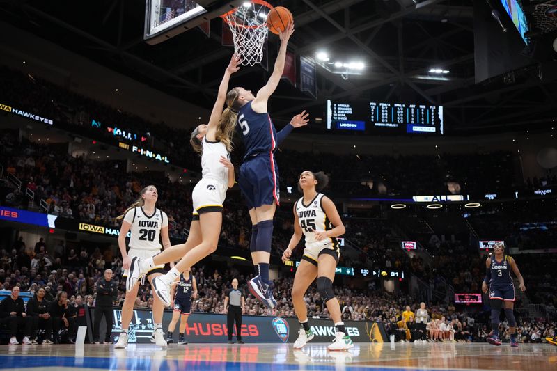 Apr 5, 2024; Cleveland, OH, USA; Connecticut Huskies guard Paige Bueckers (5) shoots against Iowa Hawkeyes guard Gabbie Marshall (24) in the third quarter in the semifinals of the Final Four of the womens 2024 NCAA Tournament at Rocket Mortgage FieldHouse. Mandatory Credit: Kirby Lee-USA TODAY Sports