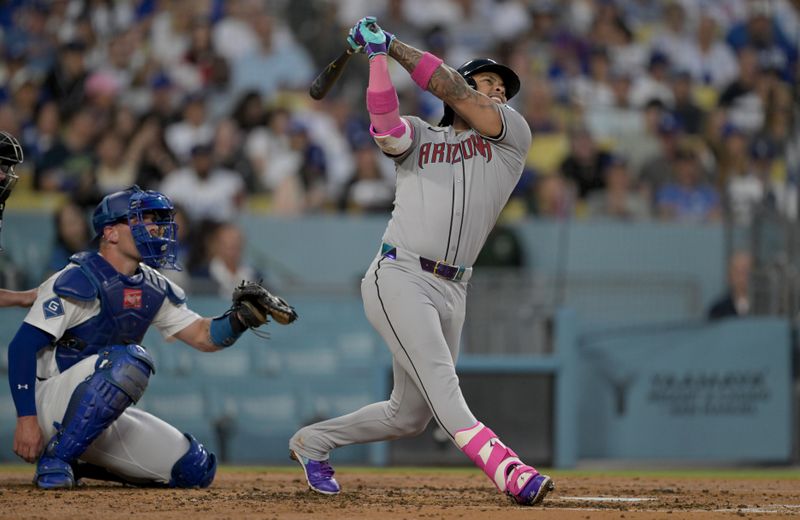 May 21, 2025; Los Angeles, California, USA; Arizona Diamondbacks second baseman Ketel Marte (4) hits a home run during the fourth inning against the Los Angeles Dodgers at Dodger Stadium. Mandatory Credit: Jayne Kamin-Oncea-Imagn Images