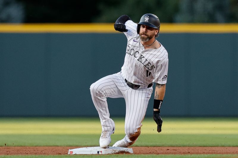 Aug 27, 2024; Denver, Colorado, USA; Colorado Rockies right fielder Jake Cave (11) slides into second on an RBI double in the first inning against the Miami Marlins at Coors Field. Mandatory Credit: Isaiah J. Downing-USA TODAY Sports