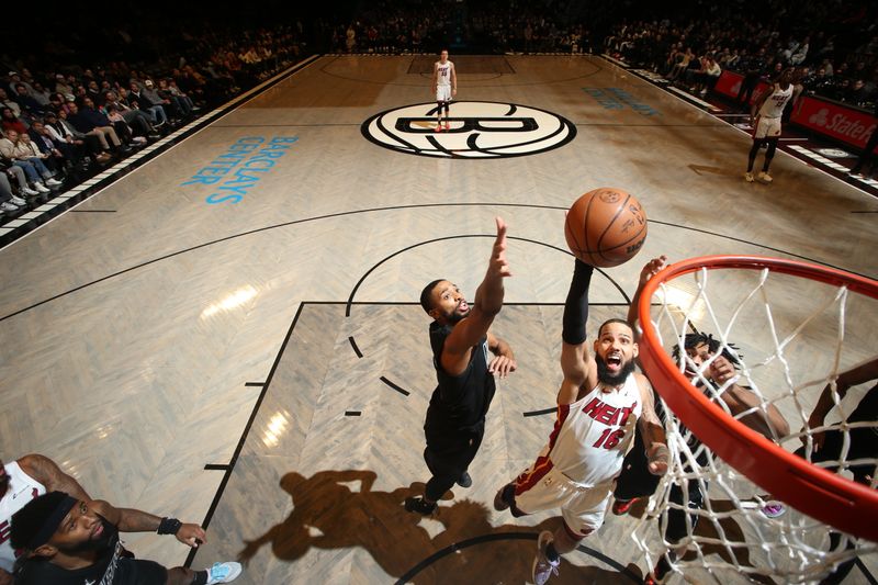 BROOKLYN, NY - JANUARY 15: Caleb Martin #16 of the Miami Heat drives to the basket during the game against the Brooklyn Nets on January 15, 2024 at Barclays Center in Brooklyn, New York. NOTE TO USER: User expressly acknowledges and agrees that, by downloading and or using this Photograph, user is consenting to the terms and conditions of the Getty Images License Agreement. Mandatory Copyright Notice: Copyright 2024 NBAE (Photo by Nathaniel S. Butler/NBAE via Getty Images)