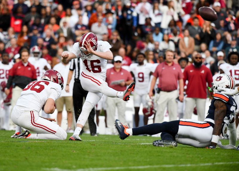 Nov 25, 2023; Auburn, Alabama, USA;  Alabama Crimson Tide place kicker Will Reichard (16) connects on a field goal during the first half against Auburn at Jordan-Hare Stadium. Mandatory Credit: Gary Cosby Jr.-USA TODAY Sports