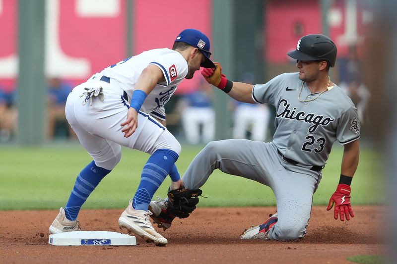 Jul 20, 2024; Kansas City, Missouri, USA; Chicago White Sox outfielder Andrew Benintendi (23) is tagged out at second base by Kansas City Royals second baseman Michael Massey (19) during the first inning at Kauffman Stadium. Mandatory Credit: Scott Sewell-USA TODAY Sports