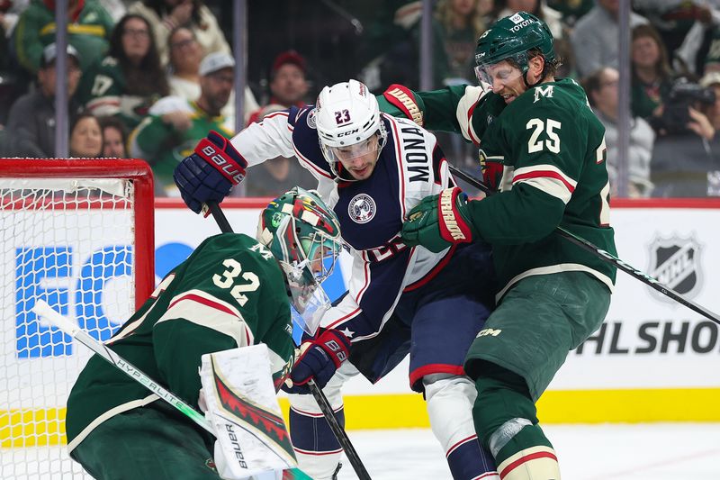 Oct 10, 2024; Saint Paul, Minnesota, USA; Columbus Blue Jackets center Sean Monahan (23) looks to shoot as Minnesota Wild goaltender Filip Gustavsson (32) and defenseman Jonas Brodin (25) defend during the first period at Xcel Energy Center. Mandatory Credit: Matt Krohn-Imagn Images