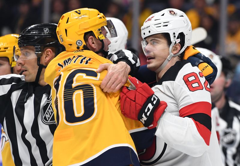 Jan 26, 2023; Nashville, Tennessee, USA; Nashville Predators left wing Cole Smith (36) and New Jersey Devils defenseman Nikita Okhotiuk (82) have to be separated after the whistle during the first period at Bridgestone Arena. Mandatory Credit: Christopher Hanewinckel-USA TODAY Sports