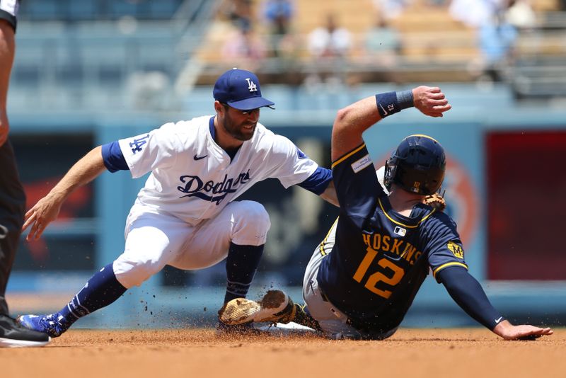 Jul 7, 2024; Los Angeles, California, USA; Los Angeles Dodgers outfielder Chris Taylor (3) tags out Milwaukee Brewers first baseman Rhys Hoskins (12) during the first inning at Dodger Stadium. Mandatory Credit: Jason Parkhurst-USA TODAY Sports