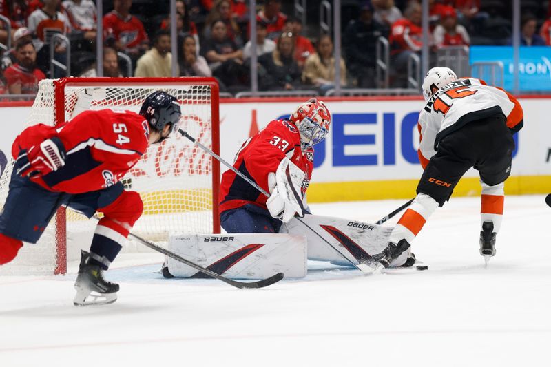 Sep 22, 2024; Washington, District of Columbia, USA; Washington Capitals goaltender Clay Stevenson (33) makes a save on Philadelphia Flyers forward Olle Lycksell (15) in the second period at Capital One Arena. Mandatory Credit: Geoff Burke-Imagn Images