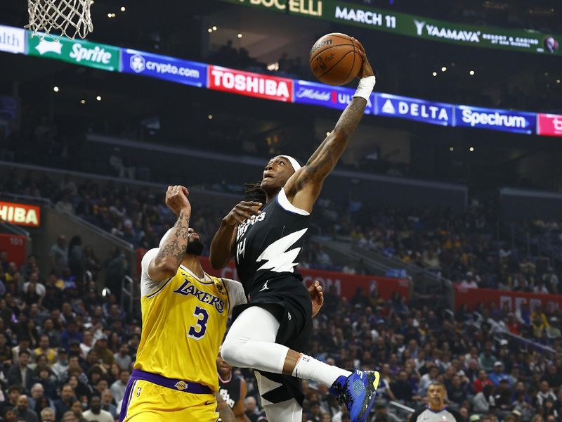 LOS ANGELES, CALIFORNIA - FEBRUARY 28:  Terance Mann #14 of the LA Clippers takes a shot against Anthony Davis #3 of the Los Angeles Lakers in the first half at Crypto.com Arena on February 28, 2024 in Los Angeles, California.  NOTE TO USER: User expressly acknowledges and agrees that, by downloading and/or using this photograph, user is consenting to the terms and conditions of the Getty Images License Agreement.  (Photo by Ronald Martinez/Getty Images)