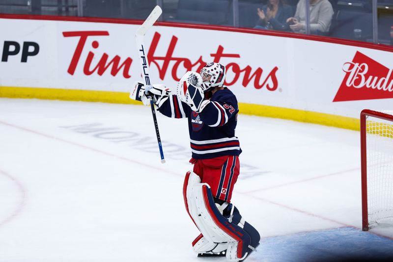 Oct 18, 2024; Winnipeg, Manitoba, CAN;  Winnipeg Jets goalie Connor Hellebuyck (37) celebrates his win against the San Jose Sharks during the third period at Canada Life Centre. Mandatory Credit: Terrence Lee-Imagn Images