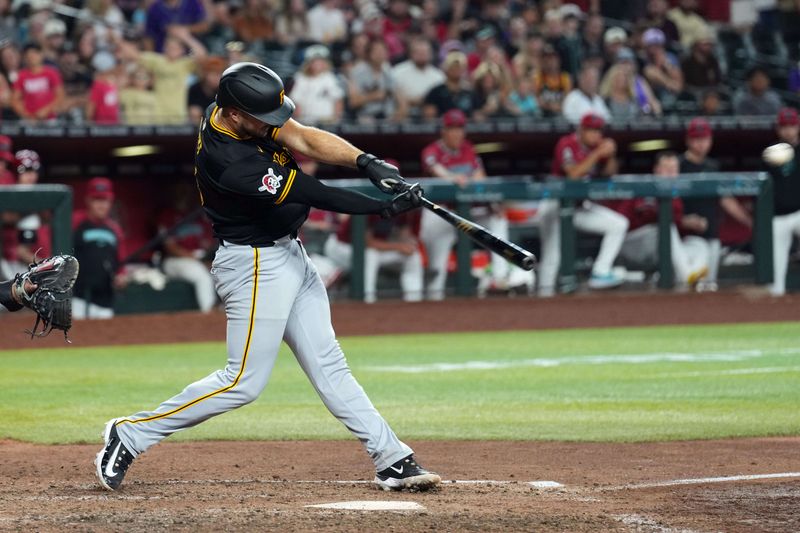 Jul 28, 2024; Phoenix, Arizona, USA; Pittsburgh Pirates catcher Joey Bart (14) hits an RBI double against the Arizona Diamondbacks during the ninth inning at Chase Field. Mandatory Credit: Joe Camporeale-USA TODAY Sports