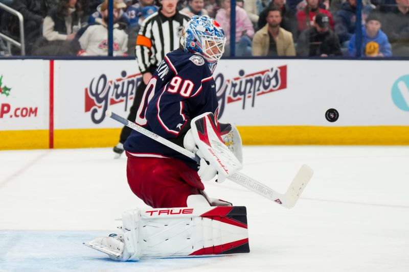 Nov 29, 2024; Columbus, Ohio, USA;  Columbus Blue Jackets goaltender Elvis Merzlikins (90) makes a save in net against the Calgary Flames in the third period at Nationwide Arena. Mandatory Credit: Aaron Doster-Imagn Images