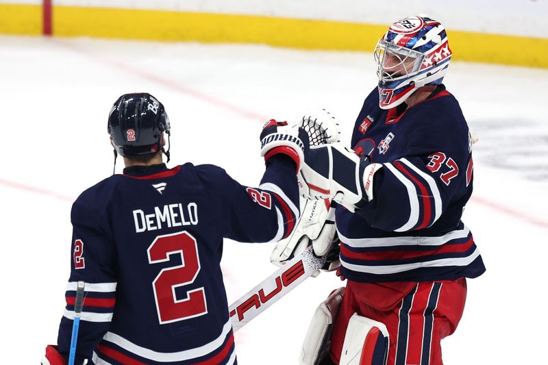 Dec 13, 2025; Winnipeg, Manitoba, CAN; Winnipeg Jets defenseman Dylan Demelo (2) and goaltender Connor Hellebuyck (37) celebrate their victory against the Washington Capitals at Canada Life Centre. Mandatory Credit: James Carey Lauder-Imagn Images