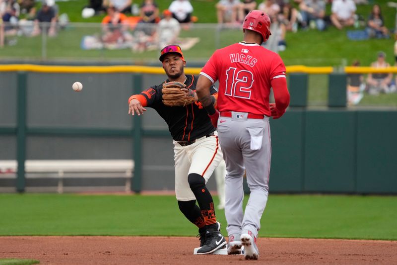 Feb 26, 2024; Scottsdale, Arizona, USA; San Francisco Giants second baseman Thairo Estrada (39) gets the force out on San Francisco Giants starting pitcher Jordan Hicks (12) in the first inning at Scottsdale Stadium. Mandatory Credit: Rick Scuteri-USA TODAY Sports