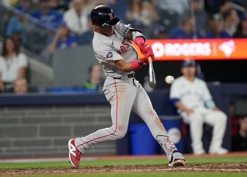 Jun 18, 2024; Toronto, Ontario, CAN; Boston Red Sox shortstop Ceddanne Rafaela (43) hits a one run single against the Toronto Blue Jays during the eighth inning at Rogers Centre. Mandatory Credit: John E. Sokolowski-USA TODAY Sports