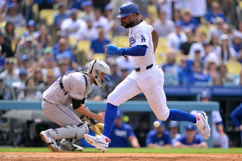 Jun 2, 2024; Los Angeles, California, USA;  Los Angeles Dodgers right fielder Jason Heyward (23) beats the throw to Colorado Rockies catcher Jacob Stallings (25) as he scores on a sacrifice fly by first baseman Freddie Freeman (5) in the eighth inning against the Colorado Rockies at Dodger Stadium. Credit: Jayne Kamin-Oncea-USA TODAY Sports