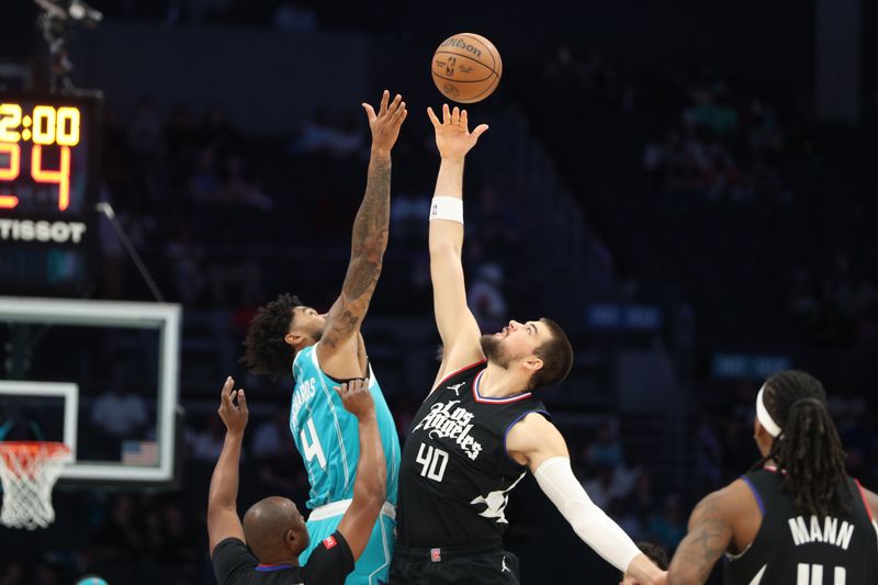 CHARLOTTE, NC - MARCH 31: Nick Richards #4 of the Charlotte Hornets and Ivica Zubac #40 of the LA Clippers go up for a jump ball on March 31, 2024 at Spectrum Center in Charlotte, North Carolina. NOTE TO USER: User expressly acknowledges and agrees that, by downloading and or using this photograph, User is consenting to the terms and conditions of the Getty Images License Agreement.  Mandatory Copyright Notice:  Copyright 2024 NBAE (Photo by Brock Williams-Smith/NBAE via Getty Images)