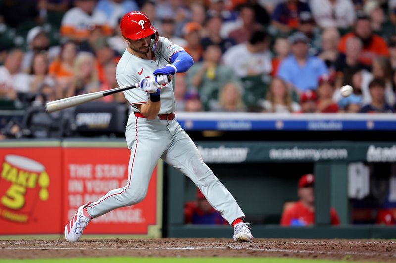 Jun 24, 2025; Houston, Texas, USA; Philadelphia Phillies shortstop Trea Turner (7) hits a single against the Houston Astros during the seventh inning at Daikin Park. Mandatory Credit: Erik Williams-Imagn Images