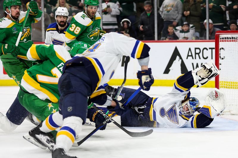 Mar 23, 2024; Saint Paul, Minnesota, USA; Minnesota Wild defenseman Brock Faber (7) scores a goal passes St. Louis Blues goaltender Jordan Binnington (50) during the third period at Xcel Energy Center. Mandatory Credit: Matt Krohn-USA TODAY Sports