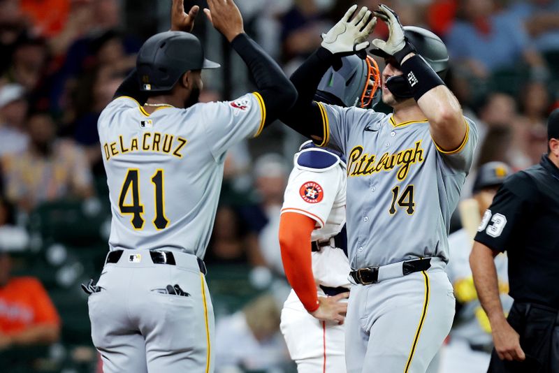Jul 31, 2024; Houston, Texas, USA; Pittsburgh Pirates catcher Joey Bart (14) is congratulated at home plate by right fielder Bryan De La Cruz (41) after hitting a two-run home run against the Houston Astros during the second inning at Minute Maid Park. Mandatory Credit: Erik Williams-USA TODAY Sports