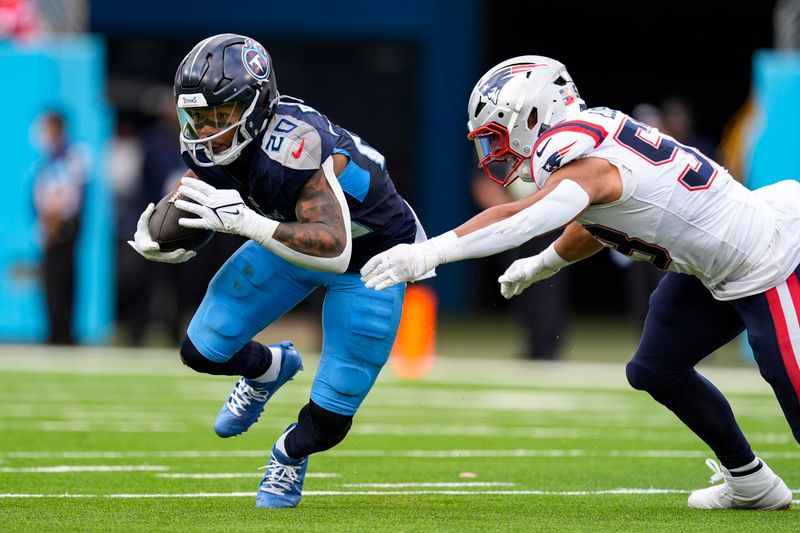 Tennessee Titans running back Tony Pollard (20) is tackled after a catch by New England Patriots linebacker Christian Elliss (53) during the first half of an NFL football game in Nashville, Tenn., Sunday, Nov. 3, 2024. (AP Photo/George Walker IV)