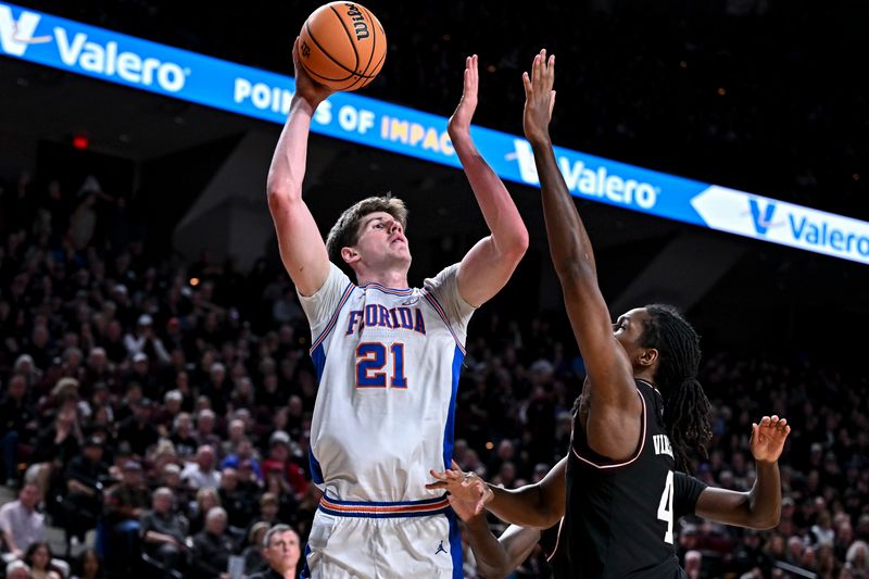 Feb 7, 2026; College Station, Texas, USA; Florida Gators forward Alex Condon (21) shoots the ball as Texas A&M Aggies forward Jamie Vinson (4) defends during the first half at Reed Arena. Mandatory Credit: Maria Lysaker-Imagn Images 